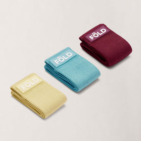 Pilates Resistance Band Bundle - Yellow, Blue, Magenta showing three colored resistance bands for fitness training.