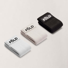 Pilates Resistance Bands Bundle - White, Timber wolf Grey, Black, featuring three resistance bands in light, medium, and heavy options.