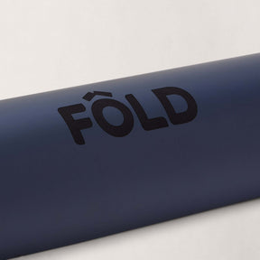 FOLD Reformer Pilates Mat - Navy showing soft material for joint-friendly cushioning in Pilates workouts.