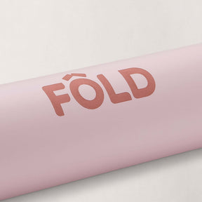 FOLD Reformer Pilates Mat - Pink logo detail on soft pink surface for comfortable Pilates workouts.