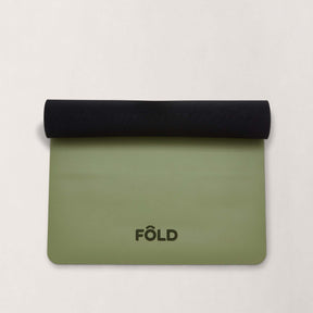 FOLD Reformer Pilates Mat - Pistachio rolled with black matting, designed for comfort and stability in workouts.