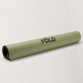 FOLD Reformer Pilates Mat - Pistachio rolled up, showcasing its soft cushioning and stability for comfortable workouts.