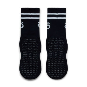 Black socks with white stripes and textured sole on a white background