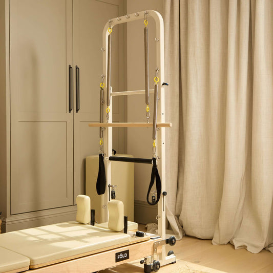 Original FOLD Reformer With TOWER showcasing its elegant design and Easi-Fold™ system in a cozy setting.