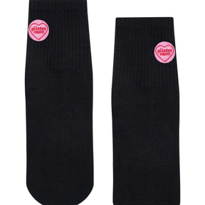 Front view of black Pilates grip socks with pink love hearts