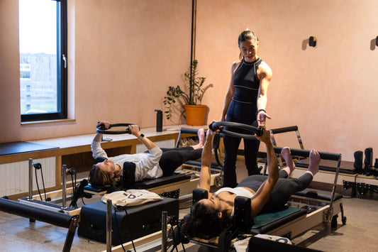 Reformer Pilates coach teaching class