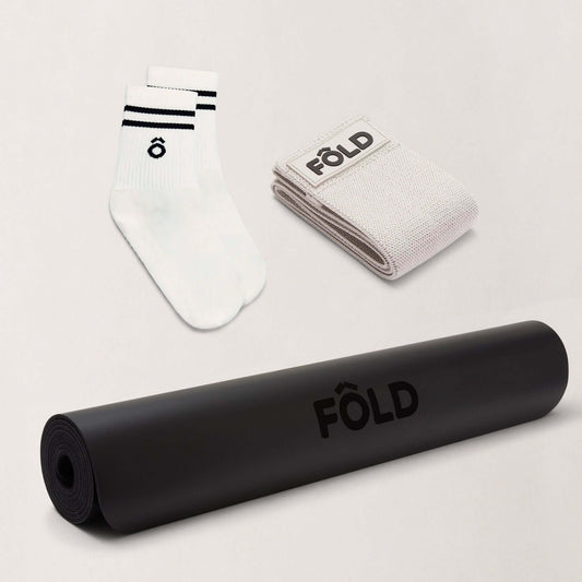 September Accessories Bundle featuring a black yoga mat, white Pilates grip socks, and resistance bands.