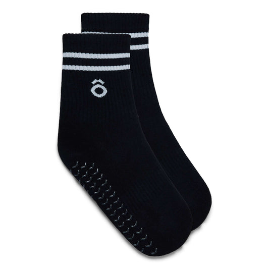 Pair of black socks with white stripes on a white background