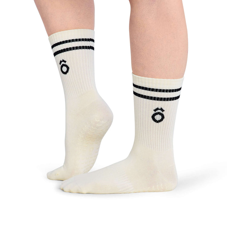 Crew Sporty Stripes Pilates Grip Socks - White displayed on feet with black stripes and grippy soles.