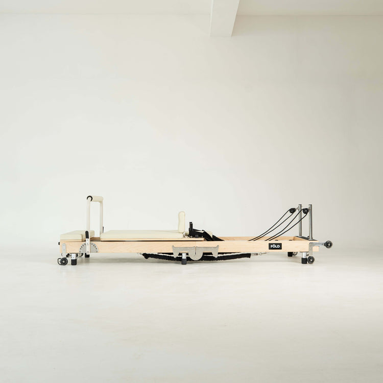 Pilates reformer machine on a white background