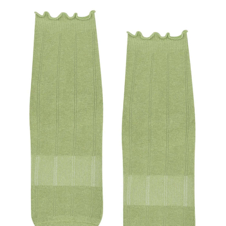 Two frilly green Pilates grip socks front view