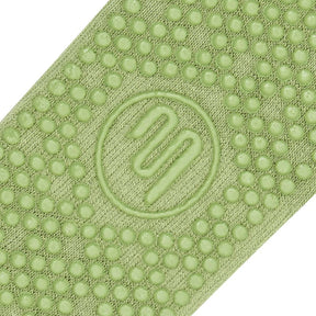 Frilly green Pilates grip sock close up of Grip sole