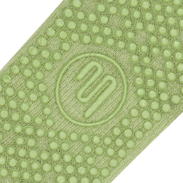Frilly green Pilates grip sock close up of Grip sole