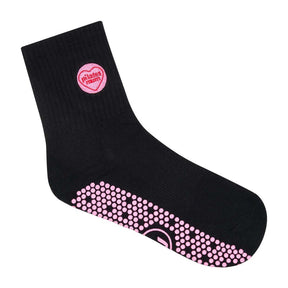 Black Pilates grip socks with pink Pilates Mum badge and pink grip sole