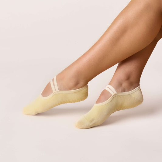 Ballet Grip Socks - Butter Yellow shown on feet for barre, yoga, and Pilates with a non-slip grip sole.