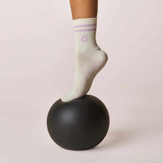 Everyday Crew Grip Socks - Lilac worn on a black Pilates ball, showcasing grip and comfort.