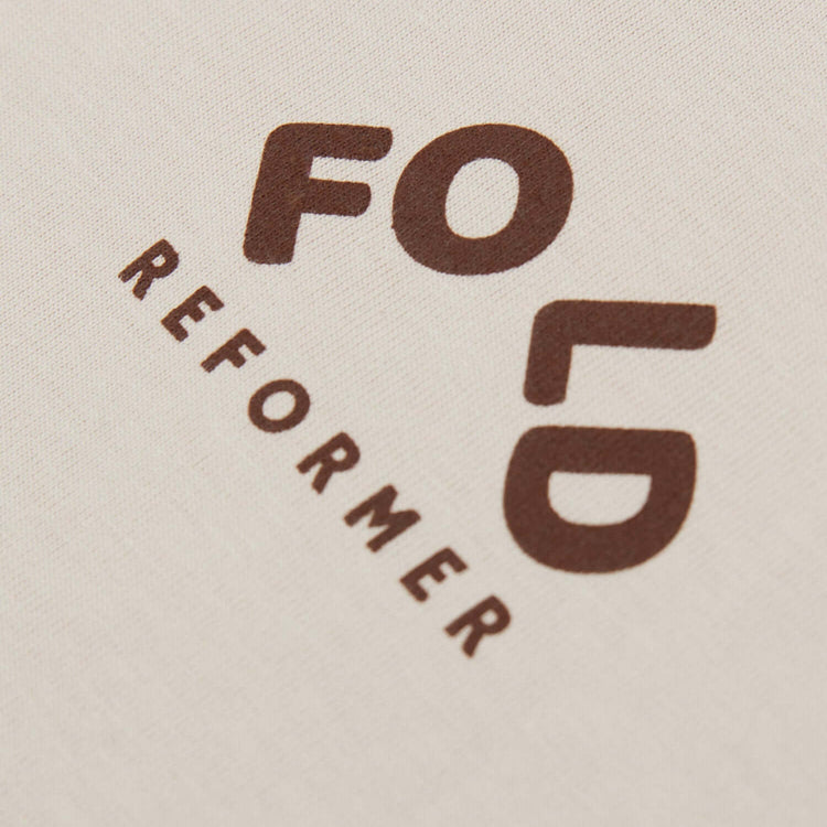 FOLD Reformer logo in brown on beige t-shirt