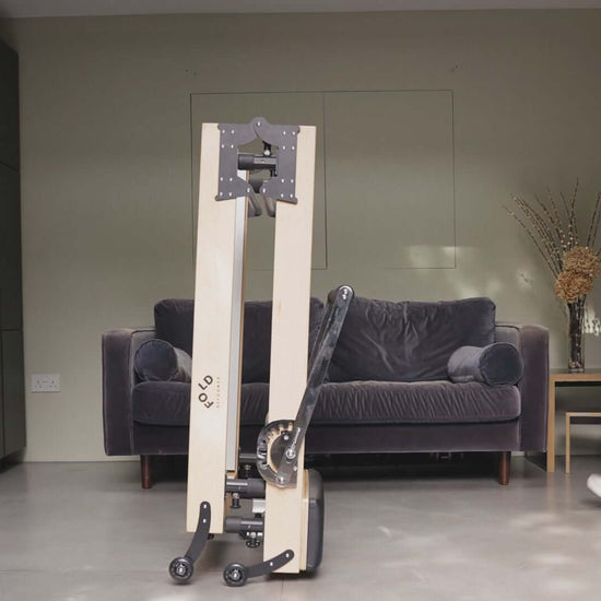Folded Reformer bed women walking towards the bed in a living room 