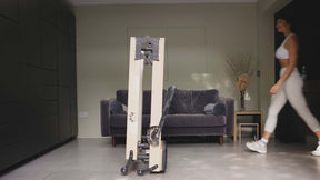 Folded Reformer bed women walking towards the bed in a living room 